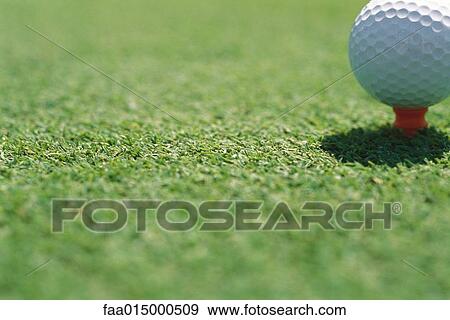 Stock Photo - Golf ball on tee, close-up. Fotosearch