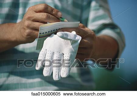 Golfer noting score, close-up of hands View Large Photo Image Stock Photography - Golfer noting score, close-up of hands. Fotosearch