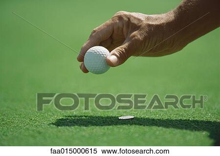 Golfer placing golf ball on turf, close-up of hand View Large Photo Image Stock Photography - Golfer placing golf ball on turf, close-up of hand. Fotosearch
