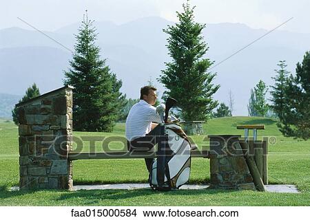 Golfer sitting on bench View Large Photo Image Picture - Golfer sitting on bench. Fotosearch
