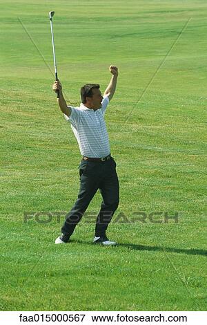 Golfer standing with arms in the air, full length View Large Photo Image Stock Photo - Golfer standing with arms in the air, full length. Fotosearch