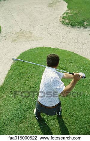 Golfer swinging, high angle view View Large Photo Image Stock Image - Golfer swinging, high angle view. Fotosearch