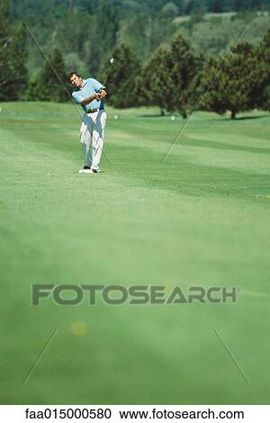 Golfer swinging, mid distance View Large Photo Image Stock Image - Golfer swinging, mid distance. Fotosearch