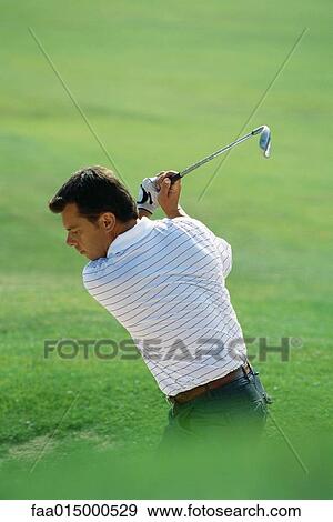 Golfer swinging View Large Photo Image Stock Photo - Golfer swinging. Fotosearch