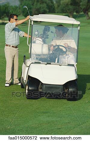 Golfer taking golf club from golf cart View Large Photo Image Stock Image - Golfer taking golf club from golf cart. Fotosearch