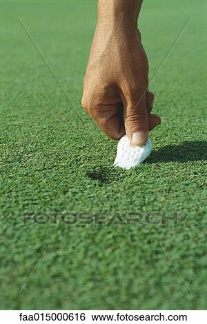 Golfer using divot repair tool on turf, close-up of hand View Large Photo Image Stock Photograph - Golfer using divot repair tool on turf, close-up of hand. Fotosearch