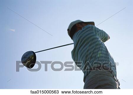 Golfer with golf club over shoulder, low angle view View Large Photo Image Stock Image - Golfer with golf club over shoulder, low angle view. Fotosearch