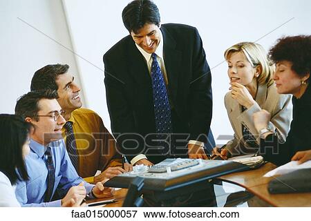 Group of business associates having conference call View Large Photo Image Stock Photo - Group of business associates having conference call. Fotosearch