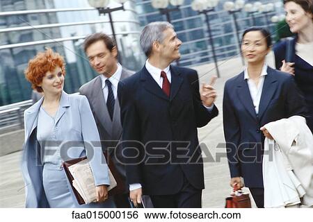 Group of business executives walking in business park View Large Photo Image Stock Photograph - Group of business executives walking in business park. Fotosearch
