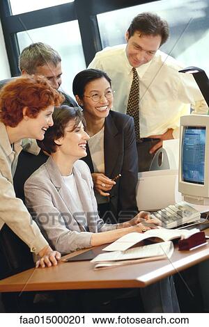 Group of businesspeople working together at desk View Large Photo Image Stock Image - Group of businesspeople working together at desk. Fotosearch
