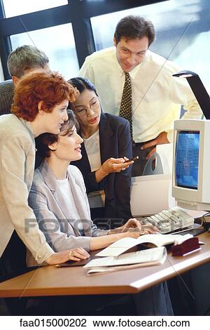 Group of businesspeople working together at desk View Large Photo Image Stock Image - Group of businesspeople working together at desk. Fotosearch
