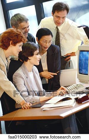 Group of businesspeople working together at desk View Large Photo Image Stock Image - Group of businesspeople working together at desk. Fotosearch