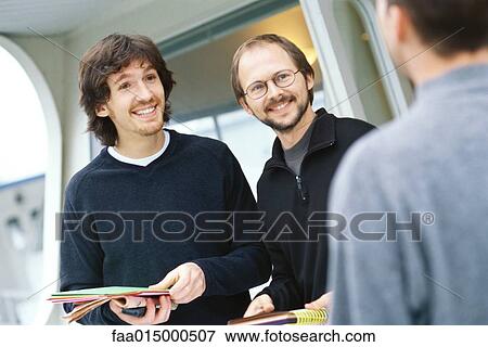 Male colleagues interacting View Large Photo Image Stock Photo - Male colleagues interacting. Fotosearch