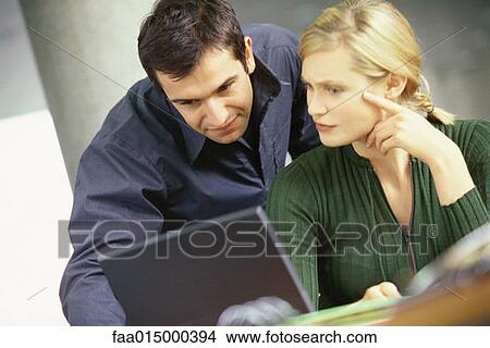 Man and woman using laptop View Large Photo Image Picture - Man and woman using laptop. Fotosearch