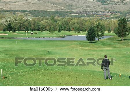 Man standing on golf course View Large Photo Image Stock Photo - Man standing on golf course. Fotosearch
