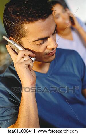 Man using cell phone, looking down View Large Photo Image Stock Image - Man using cell phone, looking down. Fotosearch