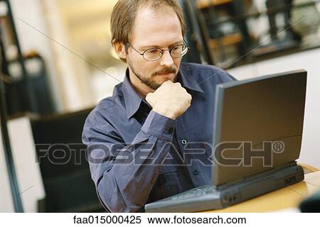 Man using laptop View Large Photo Image Stock Photography - Man using laptop. Fotosearch