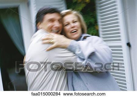 Mature couple hugging, blurred motion View Large Photo Image Picture - Mature couple hugging, blurred motion. Fotosearch