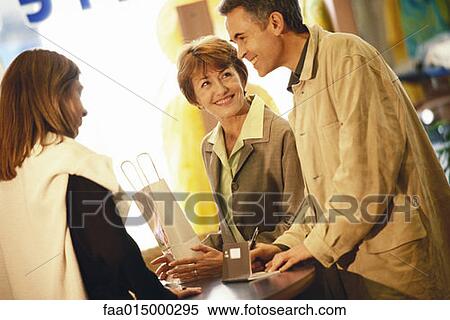 Mature couple making purchase in shop View Large Photo Image Stock Photography - Mature couple making purchase in shop. Fotosearch