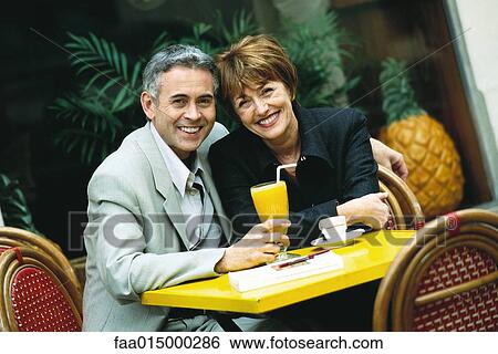 Mature couple sitting at sidewalk cafe View Large Photo Image Stock Photograph - Mature couple sitting at sidewalk cafe. Fotosearch