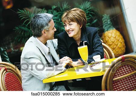 Mature couple sitting at sidewalk cafe View Large Photo Image Stock Photography - Mature couple sitting at sidewalk cafe. Fotosearch