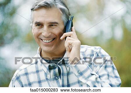 Mature man using cell phone View Large Photo Image Stock Image - Mature man using cell phone. Fotosearch