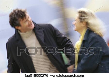 Middle aged couple walking, blurred motion View Large Photo Image Stock Photograph - Middle aged couple walking, blurred motion. Fotosearch