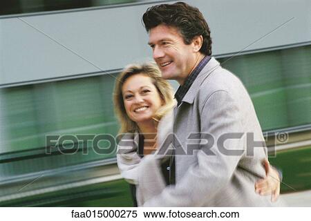 Stock Photography - Middle aged couple walking, blurred motion. Fotosearch