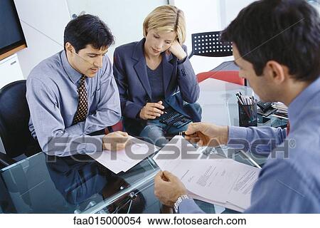 Professional couple having meeting with businessman, discussing documents View Large Photo Image Picture - Professional couple having meeting with businessman, discussing documents. Fotosearch