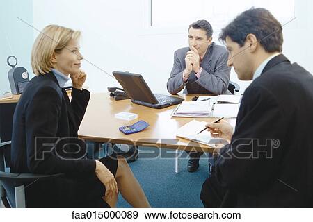 Professional couple sitting in meeting with sales executive View Large Photo Image Stock Photo - Professional couple sitting in meeting with sales executive. Fotosearch
