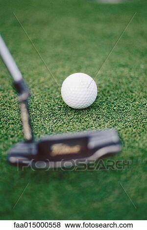 Putter posed next to golf ball on turf View Large Photo Image Stock Photo - Putter posed next to golf ball on turf. Fotosearch