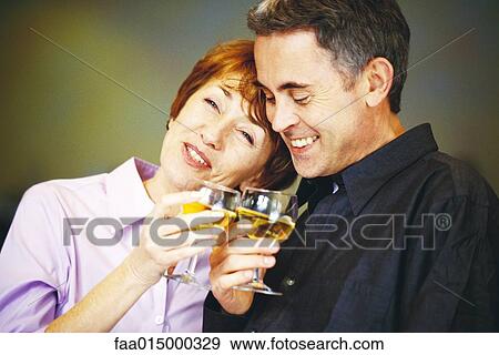 Senior couple clinking glasses of white wine View Large Photo Image Stock Photo - Senior couple clinking glasses of white wine. Fotosearch