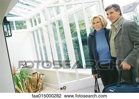Senior couple standing by sunroom View Large Photo Image Stock Image - Senior couple standing by sunroom. Fotosearch