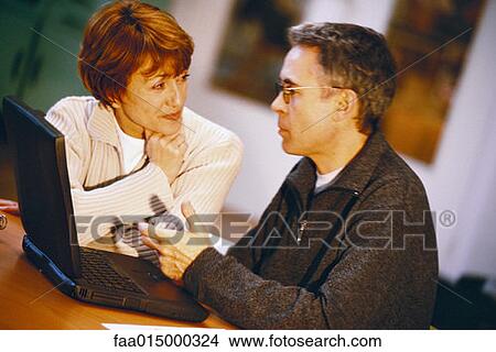 Senior couple using laptop View Large Photo Image Picture - Senior couple using laptop. Fotosearch