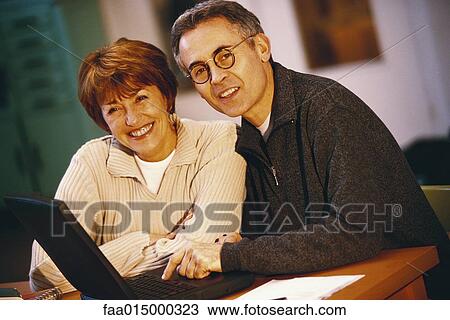 Senior couple using laptop, portrait View Large Photo Image Stock Image - Senior couple using laptop, portrait. Fotosearch
