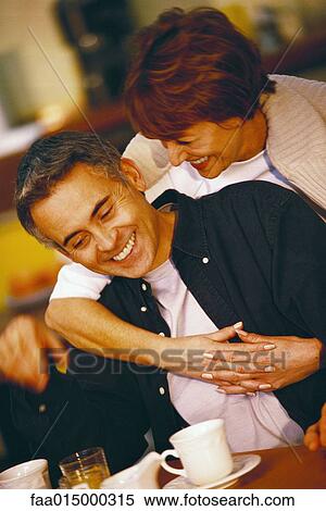 Senior couple, woman embracing man from behind View Large Photo Image Stock Photography - Senior couple, woman embracing man from behind. Fotosearch