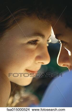 Teenage couple with heads together, close-up View Large Photo Image Picture - Teenage couple with heads together, close-up. Fotosearch