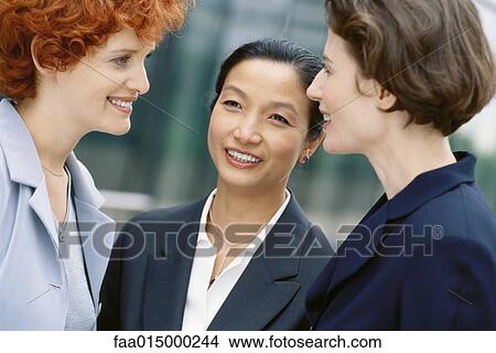 Picture - Three businesswoman talking. Fotosearch