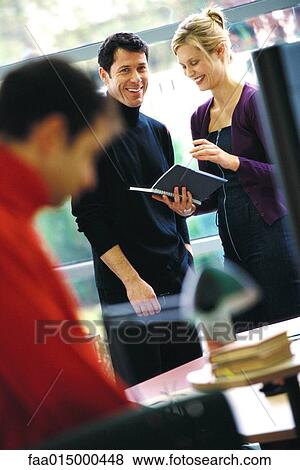 Two business colleagues looking at agenda, laughing View Large Photo Image Stock Photo - Two business colleagues looking at agenda, laughing. Fotosearch
