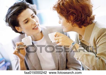 Two businesswomen having coffee View Large Photo Image Stock Image - Two businesswomen having coffee. Fotosearch