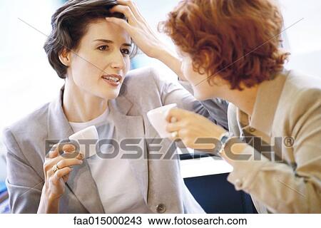 Two businesswomen having coffee View Large Photo Image Stock Image - Two businesswomen having coffee. Fotosearch