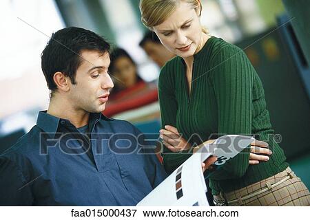 Two colleagues looking at catalogue View Large Photo Image Stock Photo - Two colleagues looking at catalogue. Fotosearch