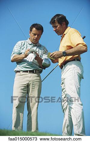 Two golfers, noting score, full length View Large Photo Image Stock Image - Two golfers, noting score, full length. Fotosearch