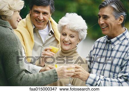 Two senior couples drinking orange juice and talking View Large Photo Image Stock Photo - Two senior couples drinking orange juice and talking. Fotosearch