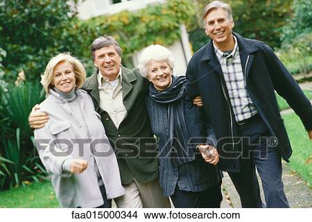 Two senior couples walking outdoors, front view View Large Photo Image Picture - Two senior couples walking outdoors, front view. Fotosearch