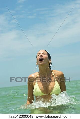 Woman emerging from sea, eyes closed and mouth open View Large Photo Image Stock Photo - Woman emerging from sea, eyes closed and mouth open. Fotosearch