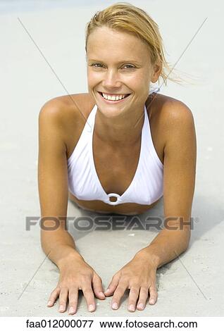 Woman in bikini lying on beach, portrait View Large Photo Image Stock Photo - Woman in bikini lying on beach, portrait. Fotosearch