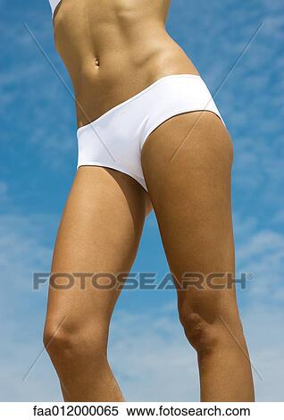 Woman in bikini, mid section, sky in background View Large Photo Image Stock Photography - Woman in bikini, mid section, sky in background. Fotosearch