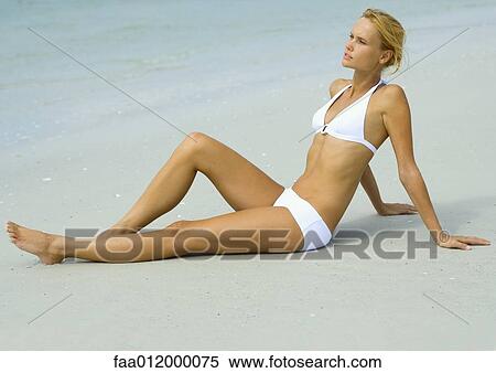 Woman in bikini sitting on beach View Large Photo Image Stock Photography - Woman in bikini sitting on beach. Fotosearch