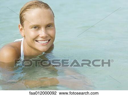 Woman in water, smiling at camera View Large Photo Image Stock Image - Woman in water, smiling at camera. Fotosearch